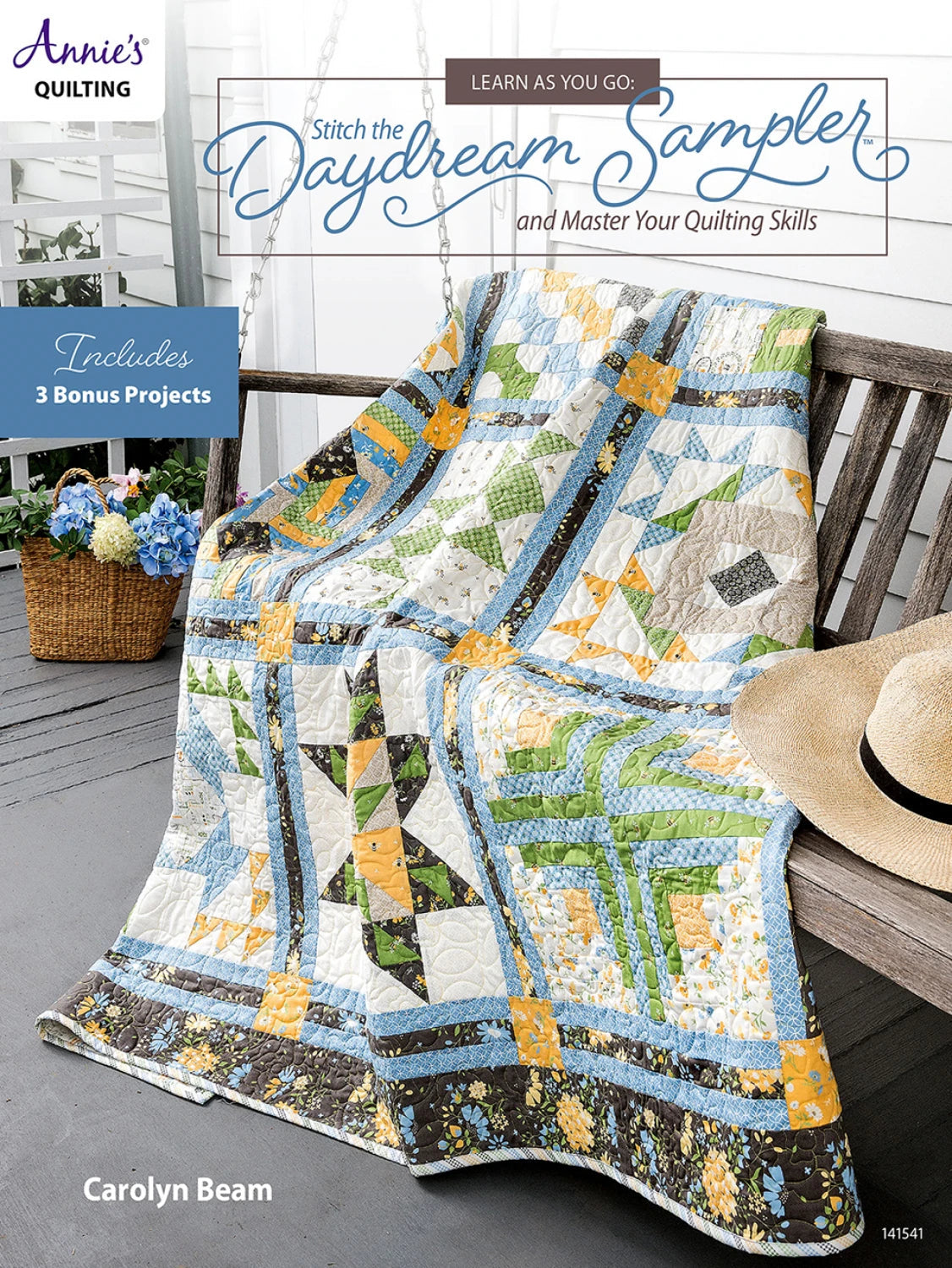 Carmon's Quilt Shop Daydream Sampler quilt pattern book featuring a colorful pieced quilt on a wooden porch swing.