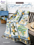 Carmon's Quilt Shop Daydream Sampler quilt pattern book featuring a colorful pieced quilt on a wooden porch swing.