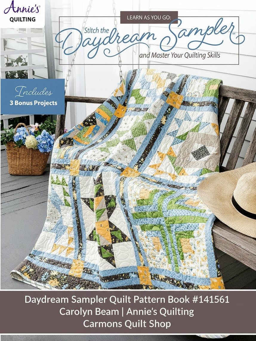 Carmon's Quilt Shop Daydream Sampler quilt pattern book featuring a colorful pieced quilt draped on a wooden bench