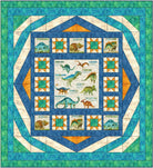 Carmon's Quilt Shop Dinosaur Adventure Quilt Kit features watercolor dinosaurs like T-Rex and Brachiosaurus on a cream background with blue and orange accents.