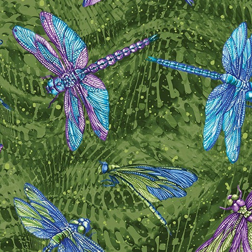 Carmon's Quilt Shop Dragonfly Wonder cotton fabric featuring vibrant blue and purple dragonflies on a green background