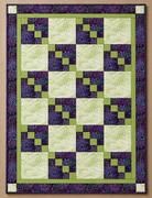 Carmon's Quilt Shop Dragonfly Wonder City Lights 3-yard quilt kit featuring purple and green geometric cotton blocks.