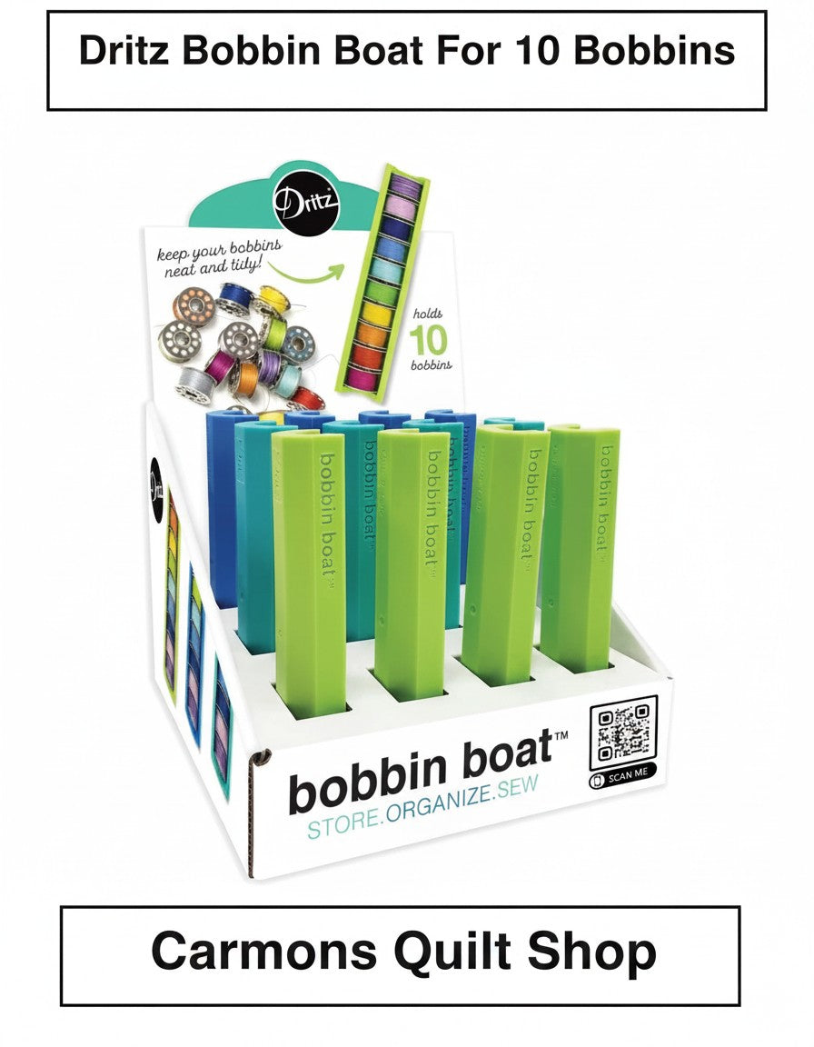 Carmon's Quilt Shop display box of green and blue Dritz Bobbin Boat organizers for sewing and quilting bobbins.