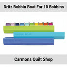 Carmon's Quilt Shop Dritz Bobbin Boat organizers in green, blue, and purple for storing sewing machine bobbins.