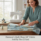 Carmon's Quilt Shop dusty aqua overlapping circle geometric 118 inch wide cotton quilting fabric on a wooden table