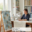 Carmon's Quilt Shop 118 inch dusty aqua cotton fabric with overlapping circle geometric print on a quilting frame