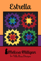 Carmon's Quilt Shop Estrella quilt pattern by Villa Rosa Designs featuring four vibrant star blocks on black fabric.