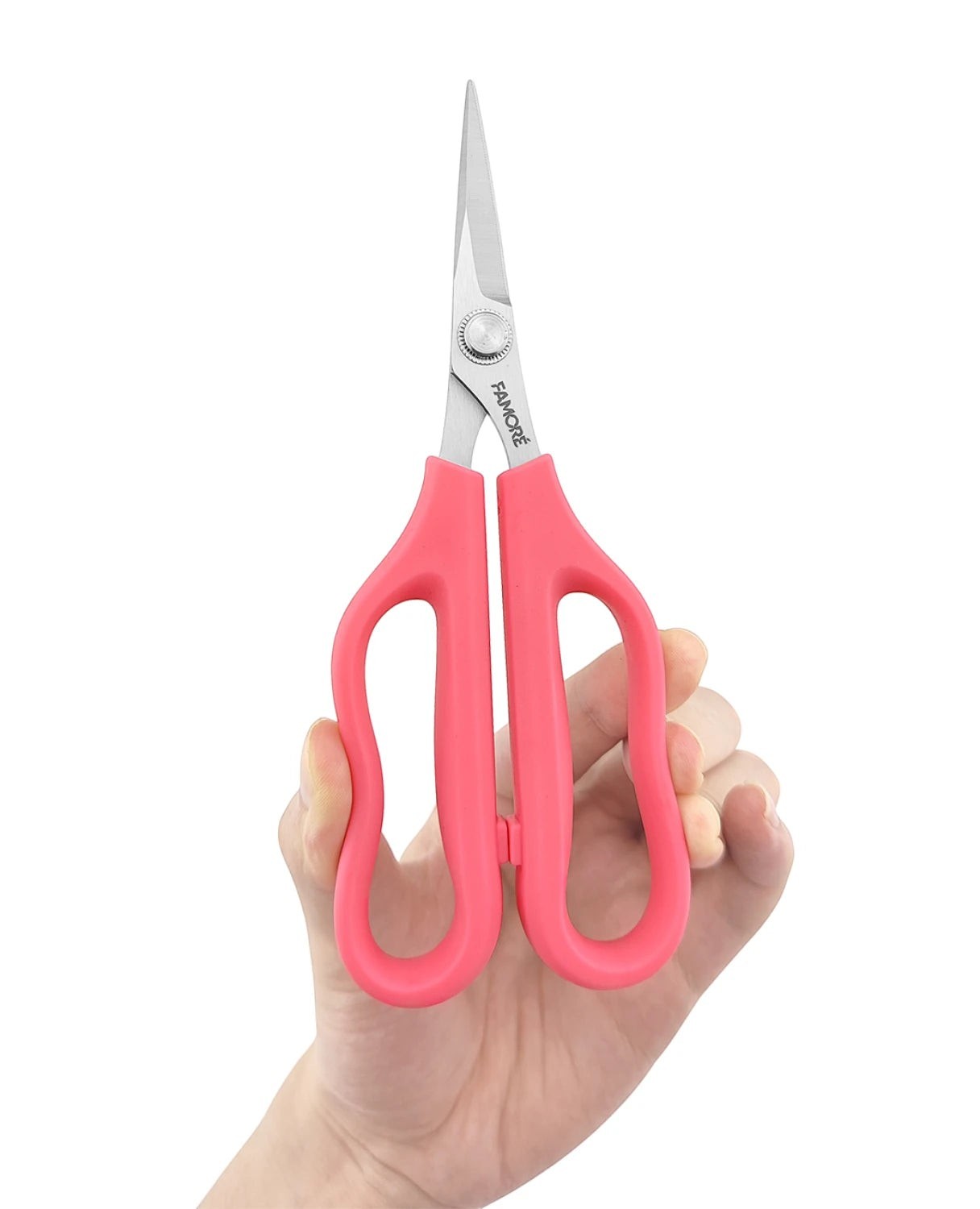 Carmon's Quilt Shop FAMORÉ 6.25-inch precision crafting scissors with pink ergonomic handles held in a hand
