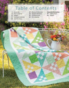 Carmon's Quilt Shop Forever Fabulous Fat Quarter Quilts book featuring a pastel pieced quilt on a garden chair