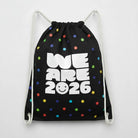 Carmon's Quilt Shop black drawstring backpack with colorful polka dots and "WE ARE 2026" text.