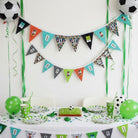 Carmon's Quilt Shop FIFA World Cup 2026 bunting kit with colorful pennants, football graphics, and green streamers.