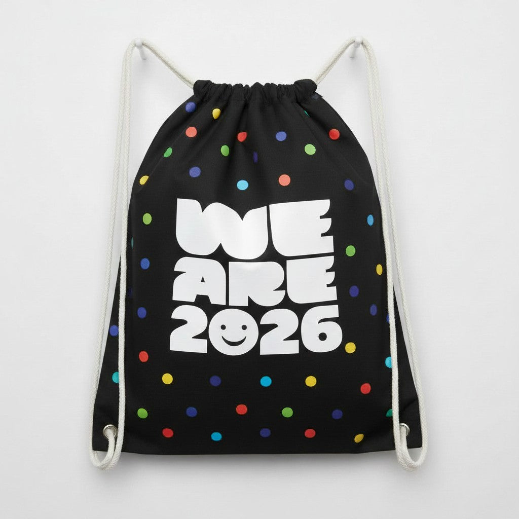 Carmon's Quilt Shop black drawstring backpack with colorful polka dots and "WE ARE 2026" text.