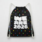 Carmon's Quilt Shop black drawstring backpack with colorful polka dots and "WE ARE 2026" text.
