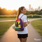 Carmon's Quilt Shop FIFA World Cup 26 drawstring backpack kit with colorful panels and FIFA logo, worn by a woman with a soccer ball.