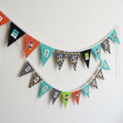 Carmon's Quilt Shop FIFA World Cup fabric panel with geometric pennants in teal, orange, black, and green with logos and text.