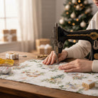 Carmon's Quilt Shop Figo Snowbound white cotton fabric with festive holiday print being sewn on a vintage machine.