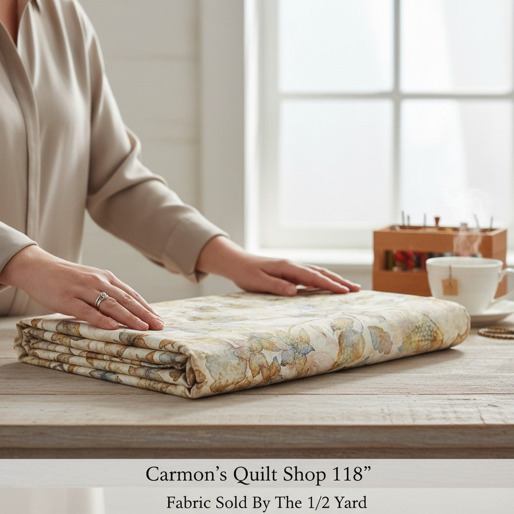 Carmon's Quilt Shop 118 inch wide cotton fabric with tonal floral print folded on a wooden table