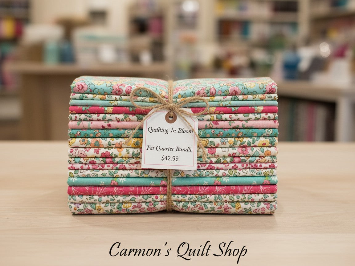 Carmon's Quilt Shop Quilting in Bloom 13-piece floral cotton fat quarter bundle tied with twine and a price tag.