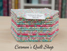 Carmon's Quilt Shop Quilting In Bloom fat quarter bundle featuring 13 floral cotton fabric squares in pink and teal.