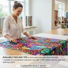 Carmon's Quilt Shop woman cutting vibrant floral geometric 108-inch wide cotton quilting fabric on a wooden table