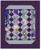 Carmon's Quilt Shop Lovely Flowers quilt pattern featuring purple and lavender floral panels with diamond accents.