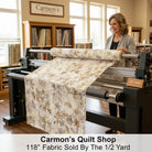 Carmon's Quilt Shop woman using a longarm machine with QT Fabrics Panorama tonal floral 118 inch wide cotton backing
