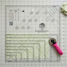 Carmon's Quilt Shop Creative Grids Ultimate Flying Geese Tool Two, a 9.5" x 9.5" acrylic quilting ruler with markings for multiple sizes.