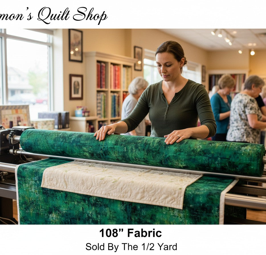 Carmon's Quilt Shop 108 inch wide forest green mottled cotton quilting fabric on a longarm machine