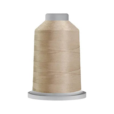 Carmon's Quilt Shop Glide 40wt trilobal polyester thread on a large king spool with a high-sheen beige finish.