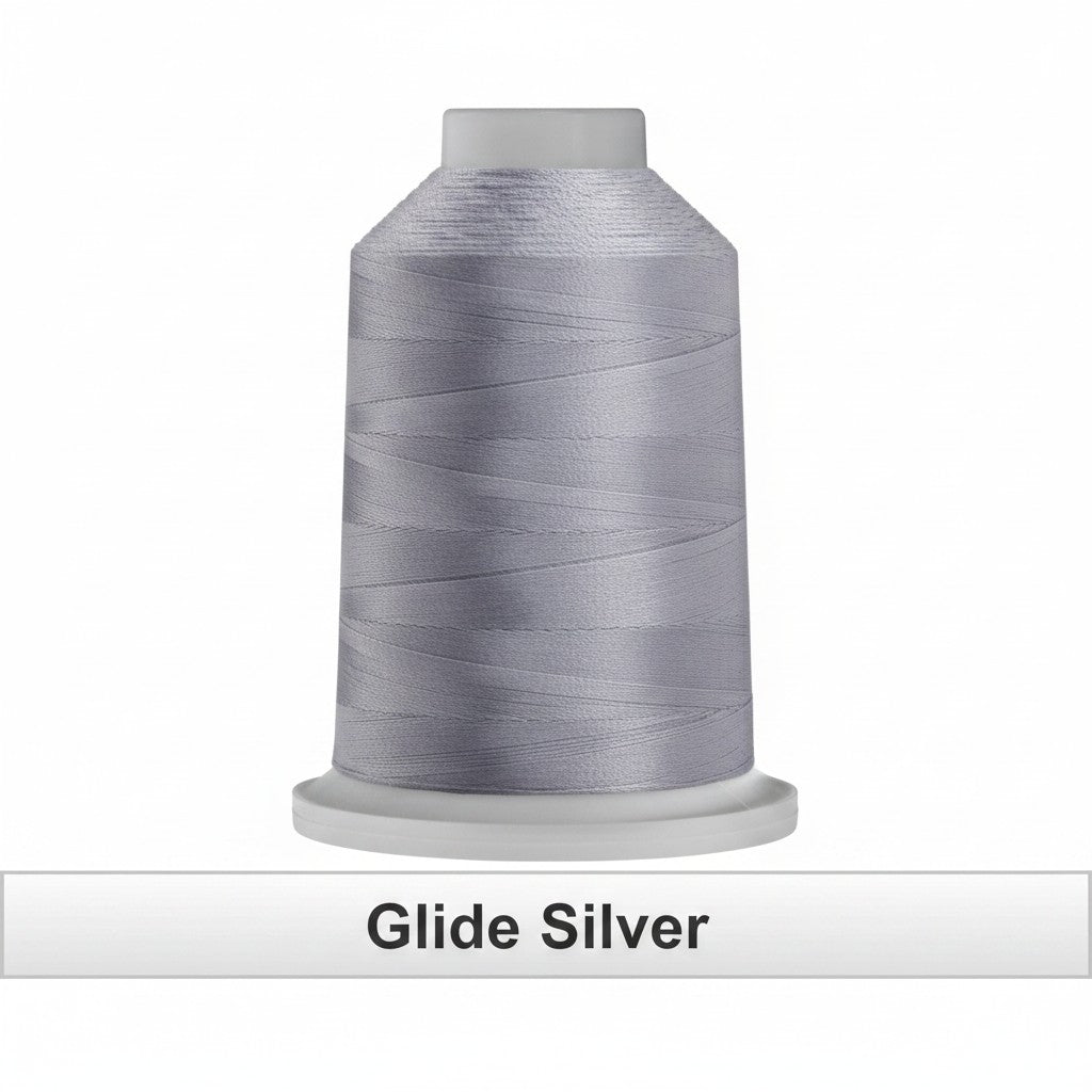 Carmon's Quilt Shop Glide 40wt silver trilobal polyester thread on a 5,500-yard king spool for quilting and embroidery.