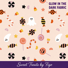 Carmon's Quilt Shop glow in the dark Halloween quilting cotton fabric featuring ghosts and candy on orange background