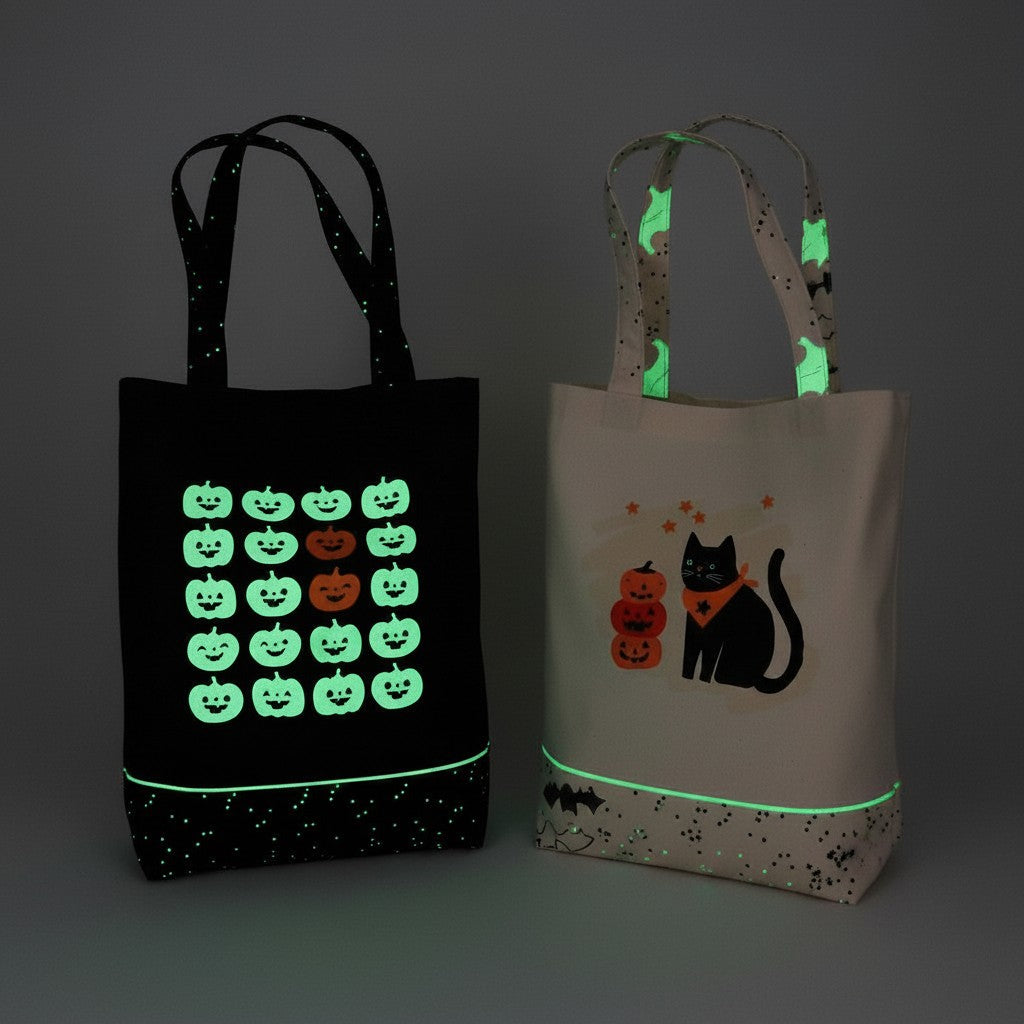 Carmon's Quilt Shop glow-in-the-dark Halloween fabric tote bags with pumpkin, cat, and ghost designs.