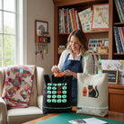 Carmon's Quilt Shop Halloween tote bag panel with glow-in-the-dark pumpkins and bats on black cotton fabric.