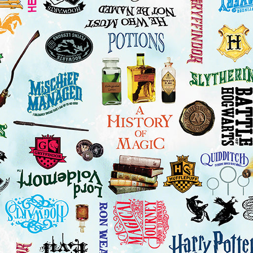 Carmon's Quilt Shop Harry Potter fabric featuring magical words, potions, and house crests on a sky blue background.