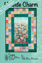 Carmon's Quilt Shop Hillside Charm quilt pattern featuring a colorful cityscape center and patchwork border