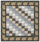 Carmon's Quilt Shop Holiday Flourish quilt kit featuring a patchwork center with a floral border in festive colors.