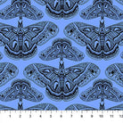 Carmon's Quilt Shop Indelible Ink cotton fabric featuring detailed black moth illustrations on a light blue background