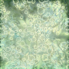 Carmon's Quilt Shop Island Batik Vintner's Treasure fabric in green and purple with a dotted bubble pattern
