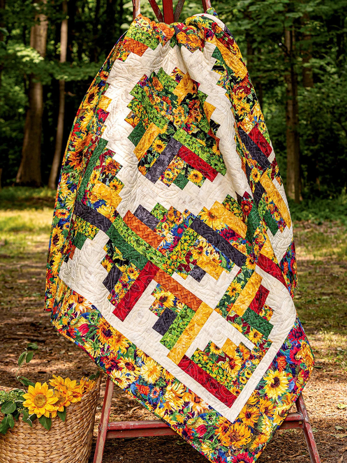 Carmon's Quilt Shop Jelly Roll quilt featuring vibrant sunflower patterns and geometric blocks hanging outdoors