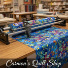 Carmon's Quilt Shop Jewel of The Sea cotton fabric featuring colorful tropical fish and coral on a blue background