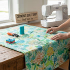 Carmon's Quilt Shop Jungle Wide Fabric, 108" 100% cotton, features abstract floral and geometric patterns in fiesta colors.