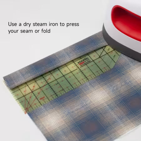 Carmon's Quilt Shop Kearing hot ironing ruler with 30-degree angle guide pressing a fabric hem with a heat press