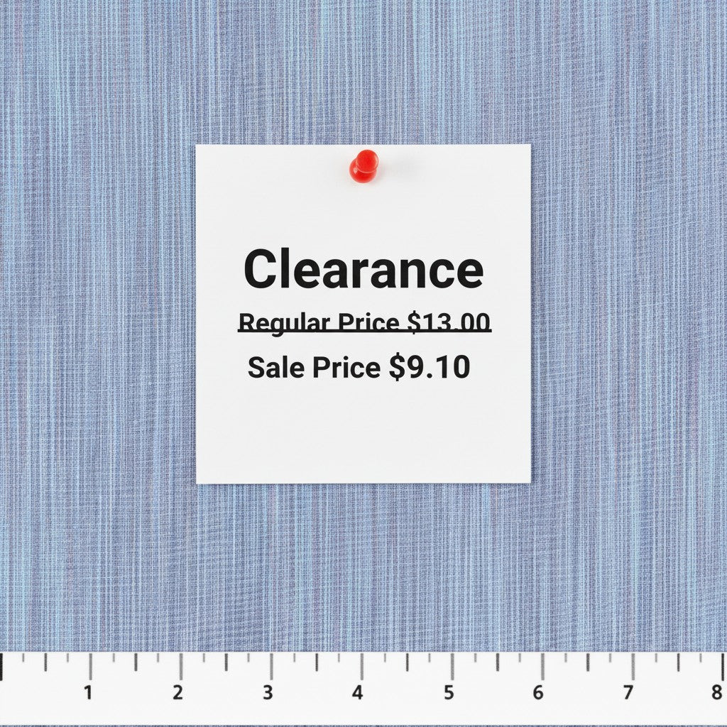 Carmon's Quilt Shop lavender space dye woven fabric with a clearance price tag and ruler for scale