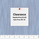 Carmon's Quilt Shop lavender space dye woven fabric with a clearance price tag and ruler for scale