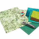 Carmon's Quilt Shop Got Your Back leaf print 108 inch wide cotton fabric with rotary cutter and quilting supplies