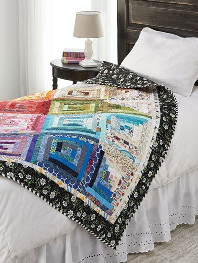 Carmon's Quilt Shop Log Cabin Variations quilt pattern book featuring a colorful patchwork quilt on a bed