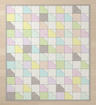 Carmon's Quilt Shop Main Street quilt kit featuring colorful geometric patchwork in soft pastel fabric prints.