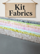Carmon's Quilt Shop Main Street quilt kit fabrics featuring floral prints in pastel colors and a solid grey fabric.