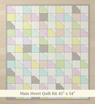 Carmon's Quilt Shop Main Street quilt kit featuring a pastel patchwork design with angled geometric fabric blocks.