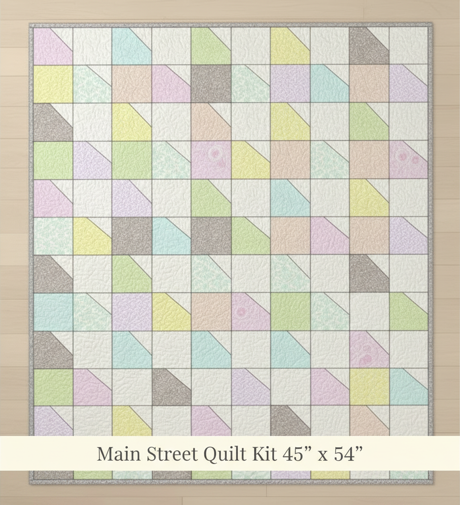 Carmon's Quilt Shop Main Street quilt kit featuring a pastel patchwork design with angled geometric fabric blocks.